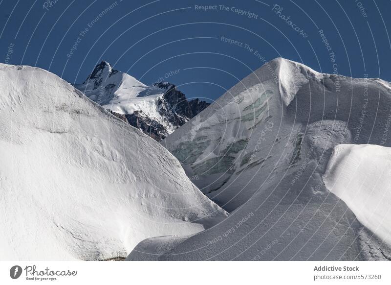 Idyllic mountain and landscape covered with snow against sky picturesque range rock covering peak top winter natural high alpine travel valley snowcapped ice