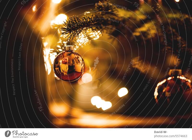 Child at Christmas in front of a Christmas tree Excitement Anticipation fir tree Glitter Ball Illuminate Pensive golden wish Cute Girl Tradition Festive