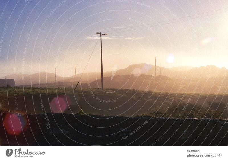 waiting for the bus Sun Electricity Electricity pylon Field Hill Morning Fog Environment Wall (barrier) Beautiful Sky lensflair Nature Ireland Bright