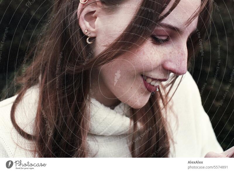 Portrait of a young, smiling woman with freckles in a white wool sweater in a heath landscape - analog 35mm Woman Young woman Large tall woman Slim Bright Joy