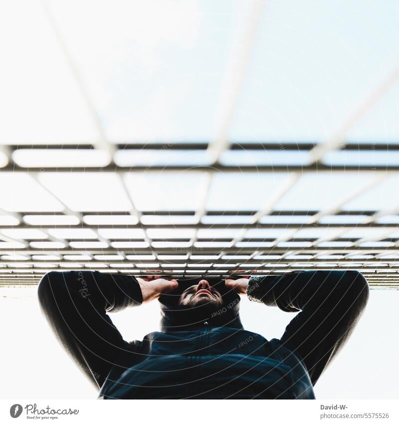 No way through - man in front of a fence locked out Refugee Border Fence Lonely Miss penned jail Barrier Captured Fear imprisonment anxiously sad Man Worries