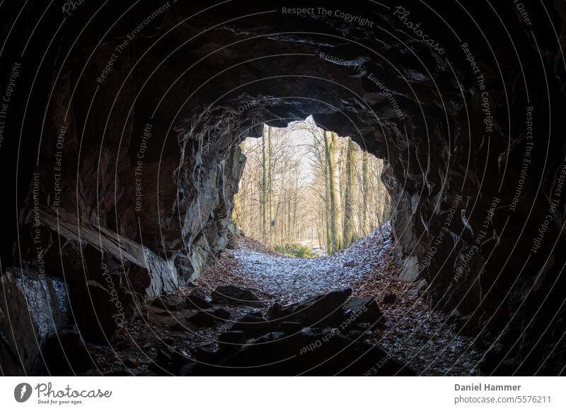 Way out of the cave - light at the end of the tunnel Cave mountain Tunnel Nature Dark Rock Day Stone Light Deserted Colour photo Sky Shadow Stalactite Mountain