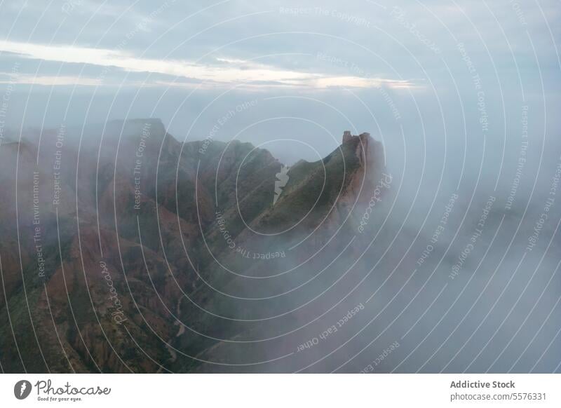 Ruins on mountain peak above clouds on foggy day sky ruin cloudy nature landscape gloomy picturesque dramatic environment barrancas de burujon toledo spain