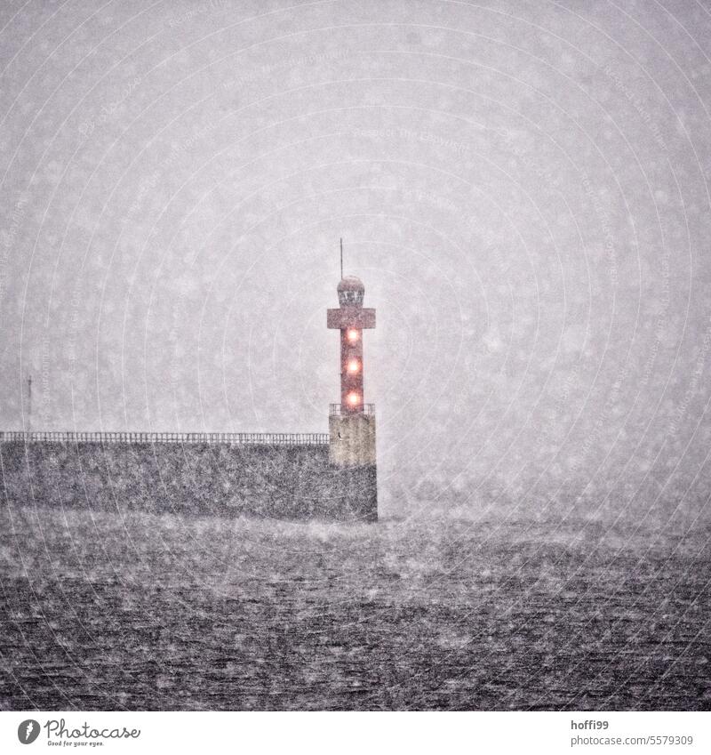 Harbor entrance with lighthouse and driving snow - winter is coming Snow Snowfall Harbour entrance Snowstorm good weather Cold Winter Weather Holiday season