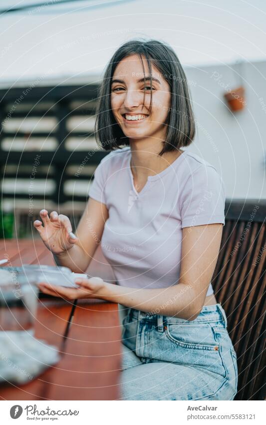 Woman smiling while holding many pills in her open hand, she is about to eat them, supplementing woman happy painkiller vitamin healthy student smart using