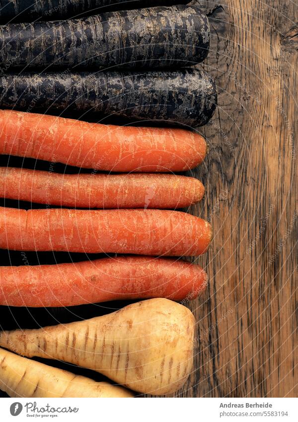 Three different root vegetables on a rustic wooden table parsnip roots delicious beta carotene carrot natural health vegan garden antioxidants tasty ingredient