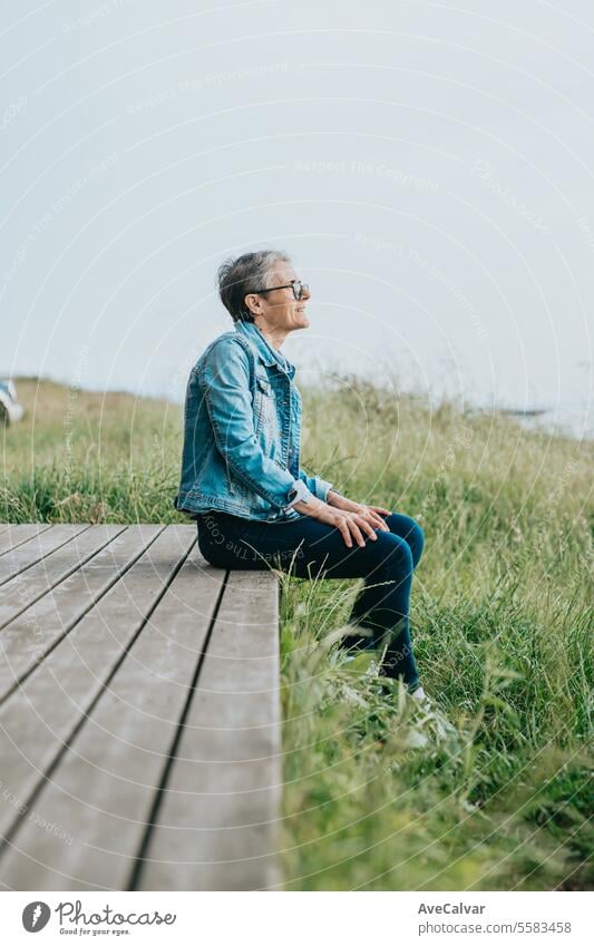 Senior smiling woman going on a trip after retiring, resting while looking at the magnificent sights mental health retirement person adult outdoors portrait