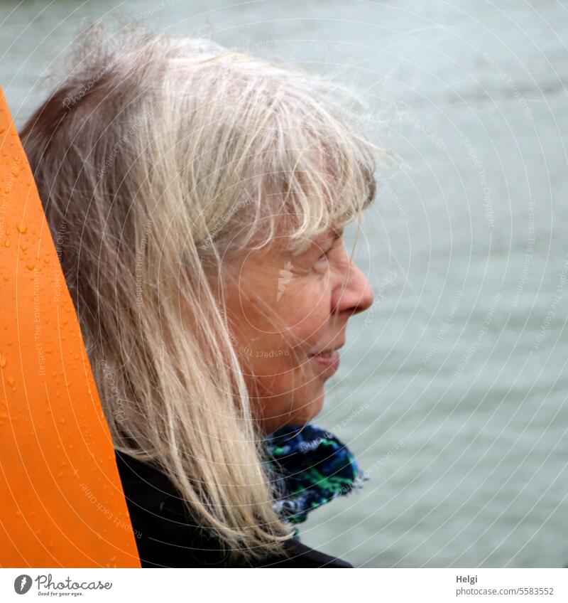 Autumn time | ruffled by the wind ... Woman Human being Senior citizen portrait Head Face Long-haired Profile Smiling windy Disheveled Blonde Neckerchief Water