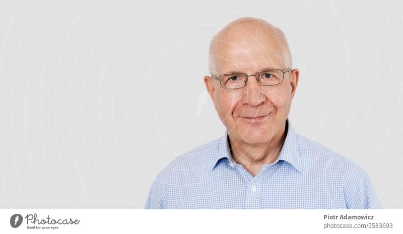 Portrait of senior man with glasses portrait old white background serious elder face isolated headshot retirement studio older copy space gray hair caucasian