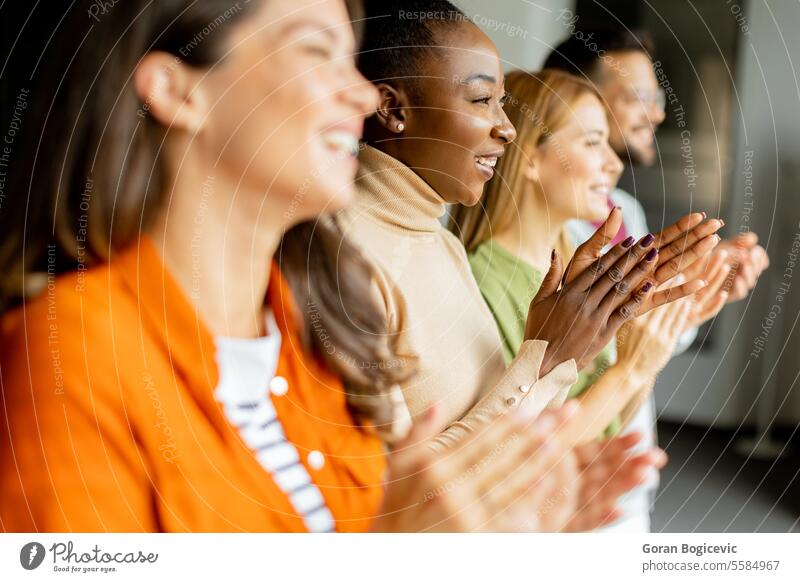 Young multiethnic startup team standing and applauding in the modern office african american black brainstorming briefing businesspeople business discussion