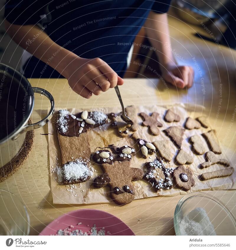 Child decorates Christmas cookies Cookie Christmas & Advent Baking children biscuits Christmas biscuit Delicious christmas time Chocolate Decoration almond cute