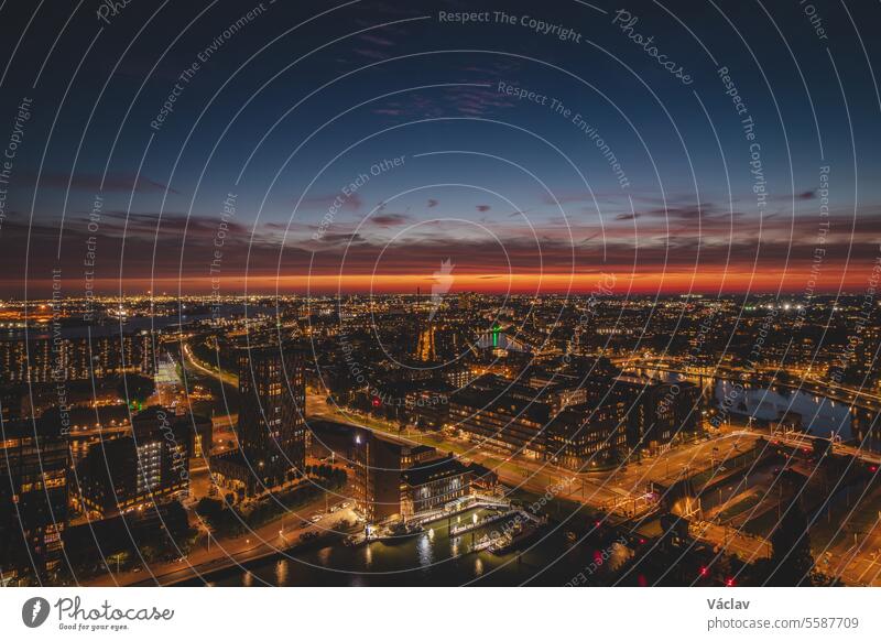 Aerial view of nightlife in the modern city of Rotterdam in the Netherlands. Red glow from the setting sun in the background rotterdam downtown twilight dutch