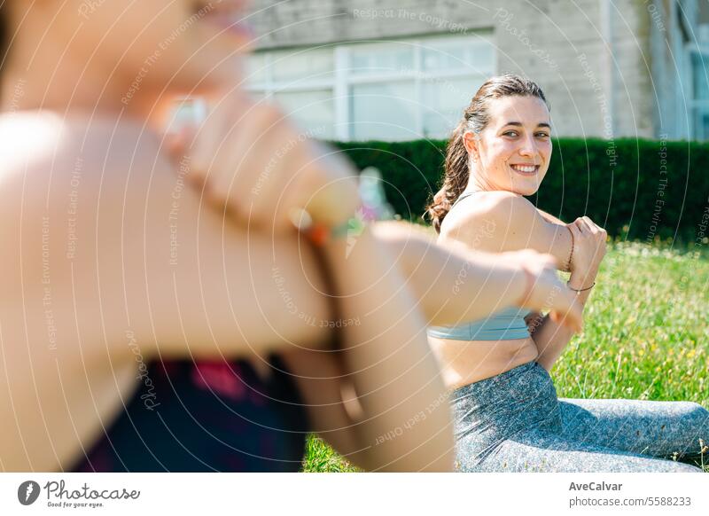 University friends resting on the campus grass while stretching to avoid injury after training. women white female dress happiness bride wedding people beauty