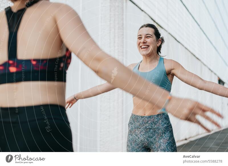 Young women doing some marked exercises outside the home, jumping and exercising their muscles. fitness sport female healthy young lifestyle training outdoor