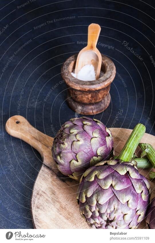 Close up of fresh artichokens vegetables ingredient vegetarian harvest healthy organic raw food green diet bunch season nutrition agriculture cutting board