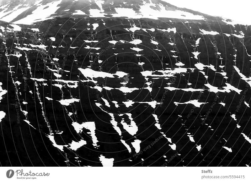 Snow tracks on a mountain side in Iceland Icelandic Traces of snow Snow melt residual snow natural pattern shape Snow forms natural forms Structures and shapes