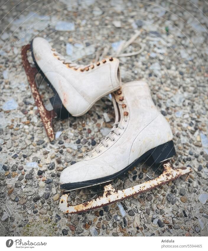 Old skates Ice-skates Rust Winter ice skating Ice-skating Winter sports Broken Trash Blade shoelaces jettisoned lost place Stone floor Broken glass