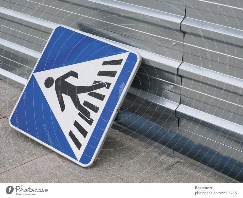 Street sign for crosswalk, lying on the sidewalk next to a construction fence Transport Pedestrian Pedestrian crossing Hoarding construction works New