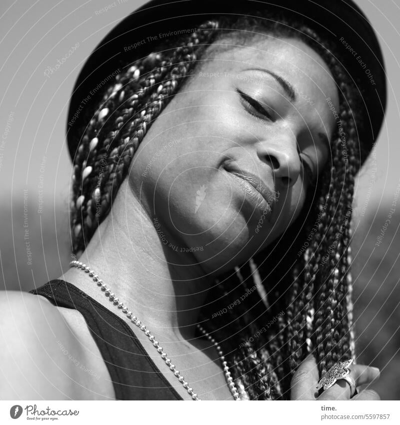 Woman with hat and braids kind Smiling Braids Hut Jewellery Looking into the camera Summer portrait Half-profile contented