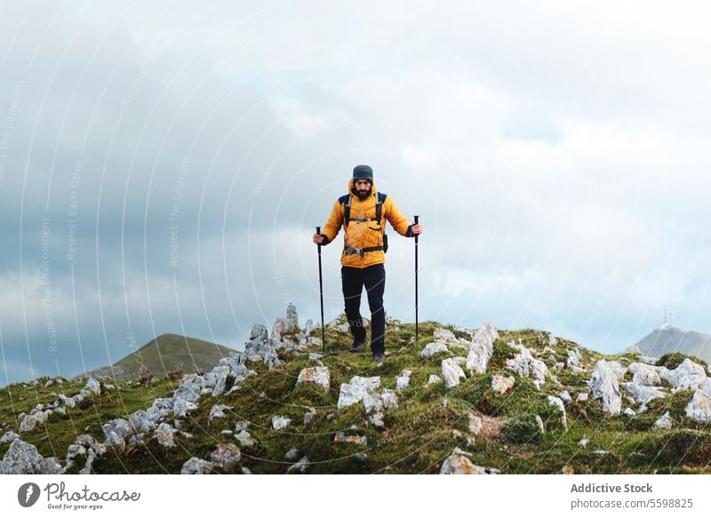 mountaineers hiking in the mountains man adult young caucasian trekking hike peak cloudy wilderness walking sport extreme exploration trip alone active outdoor