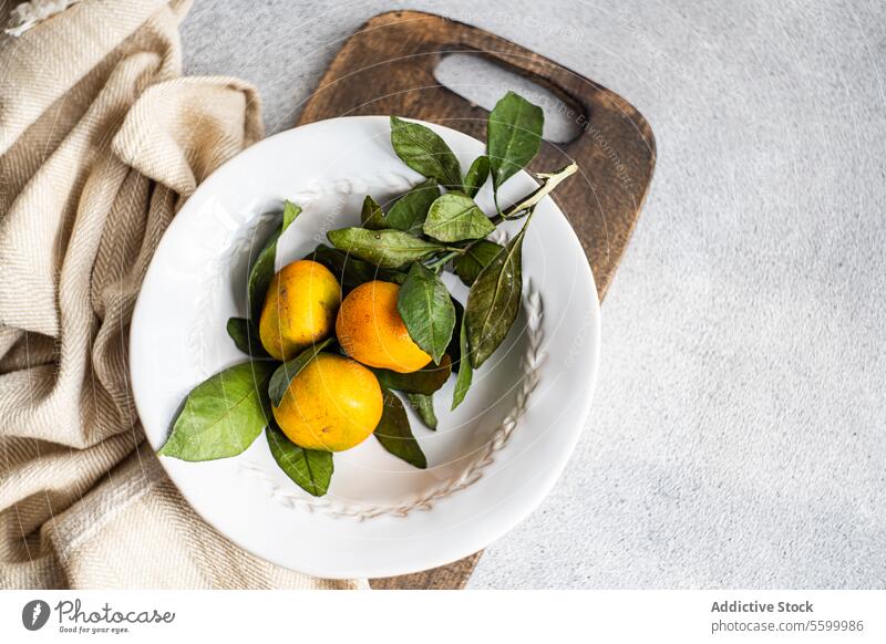 Rustic Charm with Citrus Accents rustic charm tangerine citrus white plate textured beige napkin simplicity fresh fruit organic tableware classic natural