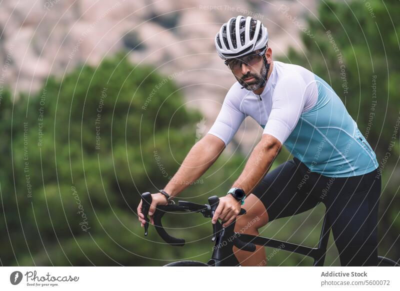 Mountain road biking cyclist road bike mountain jersey white blue helmet cycling outdoor sport ride male gear wheel handlebar seat pedal fitness nature athletic