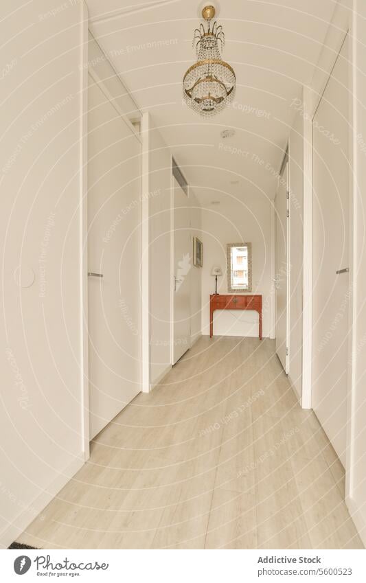 Long white hallway with doors and walls long apartment luxury perspective chandelier table mirror floor empty corridor style light copy space contemporary clean