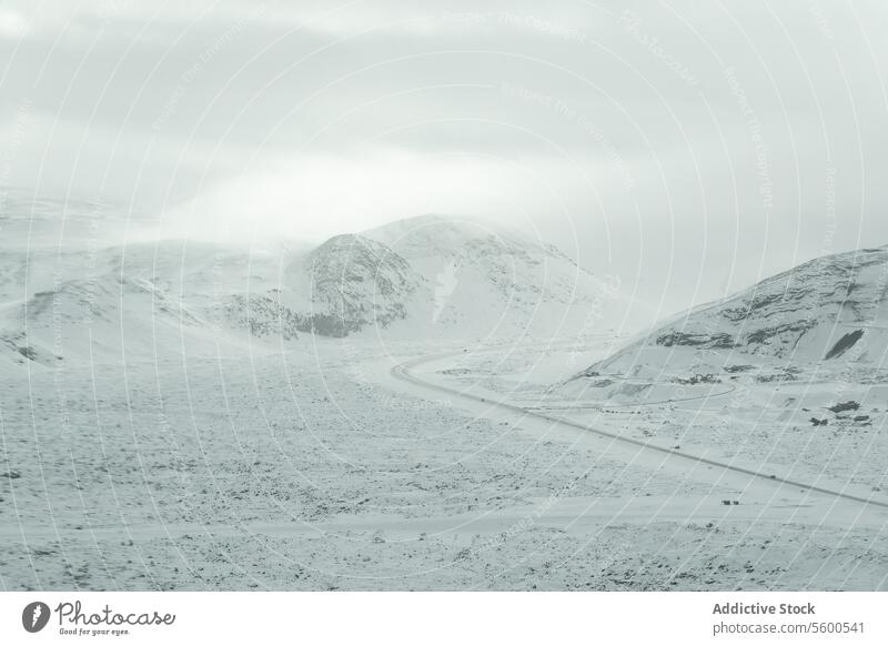 Aerial view of Misty Snow Mountains misty ethereal snow-covered hill quiet isolation winter landscape gentle vast nature serene tranquil frosty cold overcast