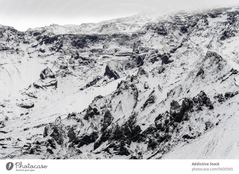 Aerial view of rugged snowy landscape with rocks terrain contrast harsh beauty complexity winter nature cold outdoor stark frost wilderness white desolate rough