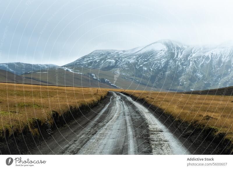 Serene Icelandic Highlands with Snow-Capped Mountains iceland highlands mountain snow road gravel field landscape nature travel serene calm quiet outdoors