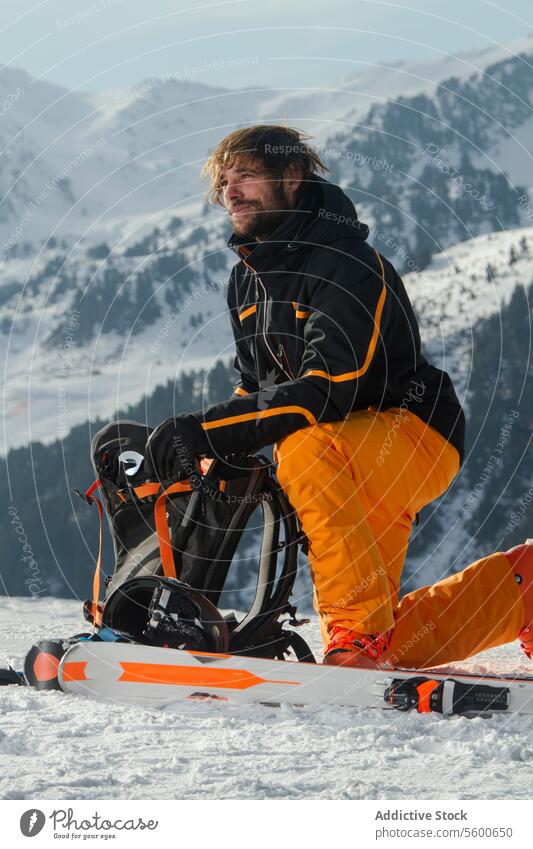 Skier taking a break amidst Swiss Alps scenery skier swiss alps mountain snow man rest gear landscape winter sport outdoor leisure relaxation nature peak