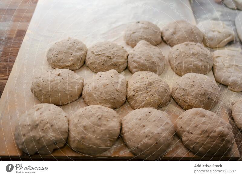 Loaf-shaped bread dough on the table loaf bakehouse bakery wheat oven hot factory production food fresh tasty industry preparing flour workplace pastry