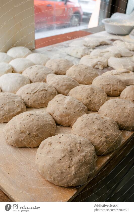 Loaf-shaped bread dough on the table loaf bakehouse bakery wheat oven hot factory production food fresh tasty industry preparing flour workplace pastry