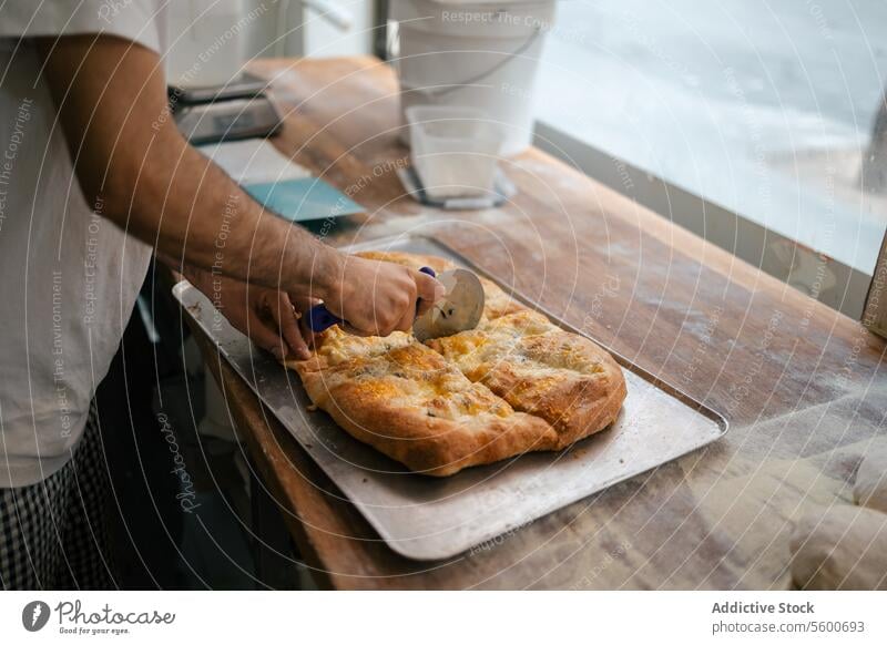 Detail shot of hands cutting pizza food fresh cheese close-up cutter italian restaurant dinner traditional meal delicious oven dough mozzarella cuisine pizzeria