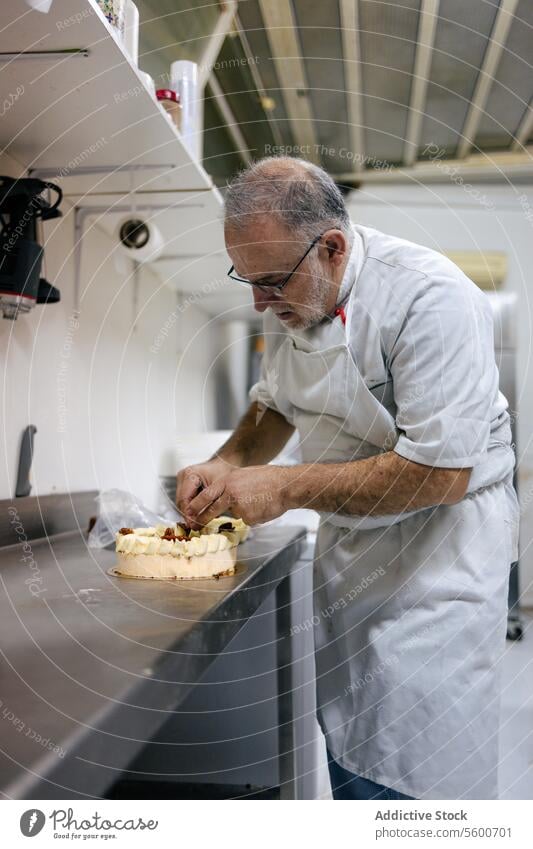 Pastry chef decorating a cake man pastry dessert sweet food decoration kitchen professional tasty cream delicious bakery preparation gourmet making