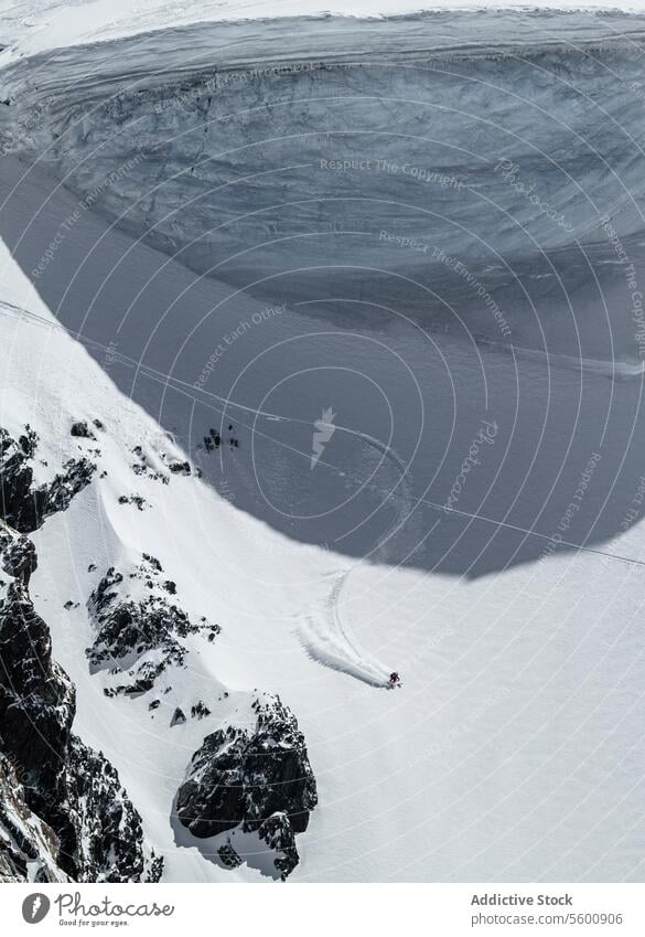 From above of anonymous snowboarder jumping from mountain in winter day at Swiss Alps landscape swiss alps snowy slope rock sunny covering top natural nature