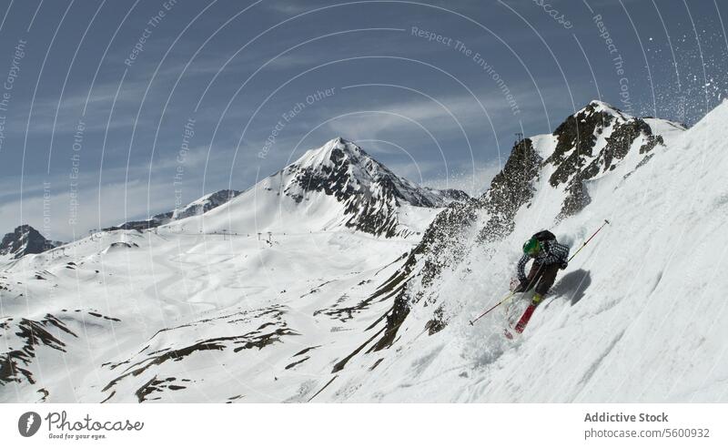 Anonymous person skiing on snowy mountain at Swiss Alps on sunny day skier winter vacation enjoy swiss alps drone unrecognizable ride covering from above white