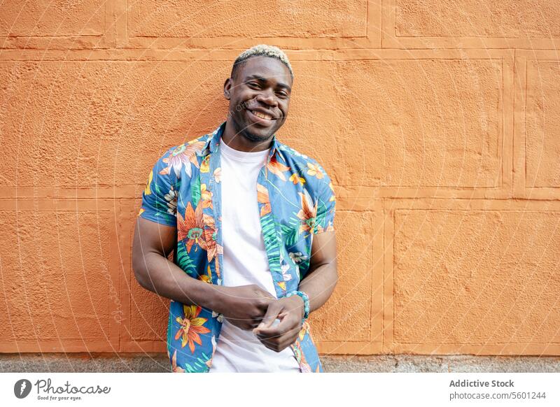 Portrait of a young black man in the street portrait smile smiling happiness urban african city lifestyle male person adult guy handsome modern casual outdoors