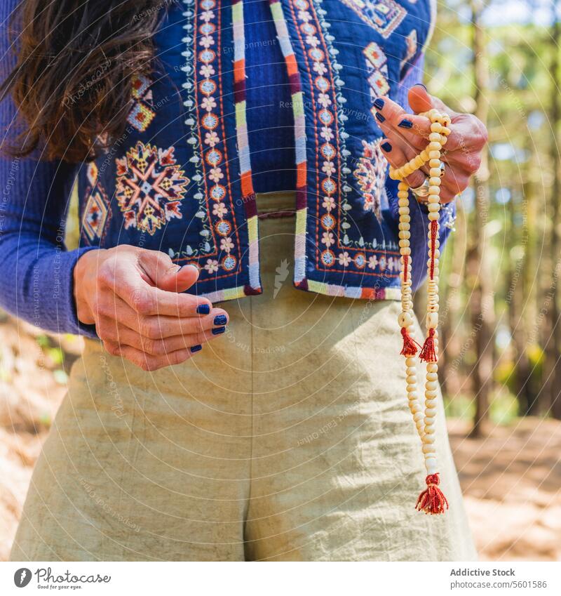 Close up of a woman holding a japa mala. adult bead buddhism calm calming calmness close up closeup concentration contemplation energy esoteric faith female