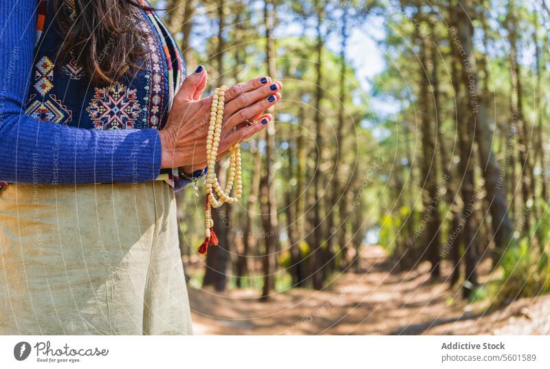 Close up of clasping hands holding a japa mala.  Copy space adult bead buddhism calm calming calmness close up closeup concentration contemplation copy space