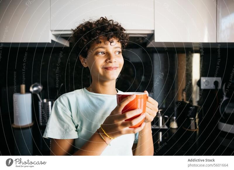 Girl drinking a cup of milk Family Preteen daughter adorable after school cheerful child childhood children everyday routine family life family with one child