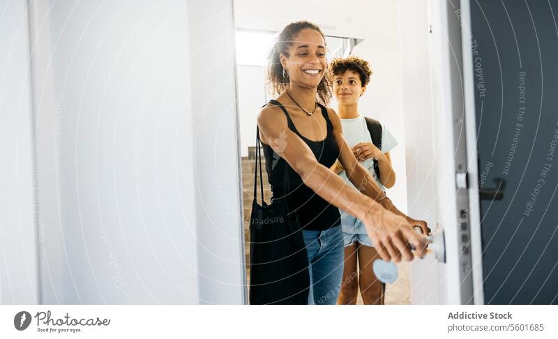 Mother and her daughter arriving home Family Preteen daughter adorable affectionate after school arrive bonding cheerful child childhood children cute day door