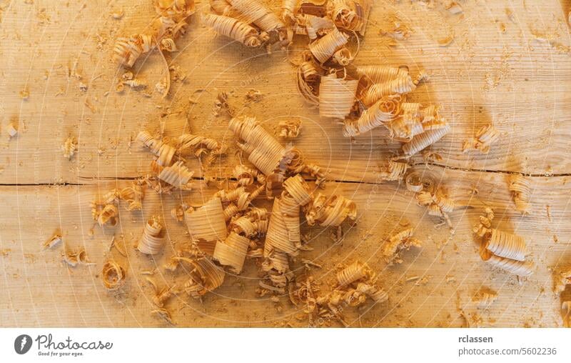 wood shavings in variety of sizes on a table, top view old-fashioned carpenter tools carver blade workshop antique carving equipment handmade wooden timber