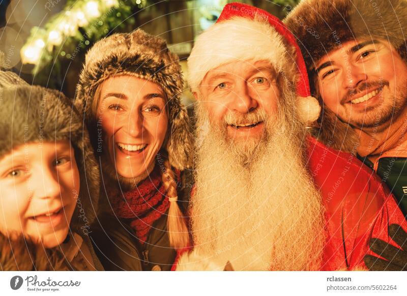 Family and Santa Claus sharing a happy moment at a Christmas market, illuminated by festive lights tourist costume merry christmas hot chocolate traditional