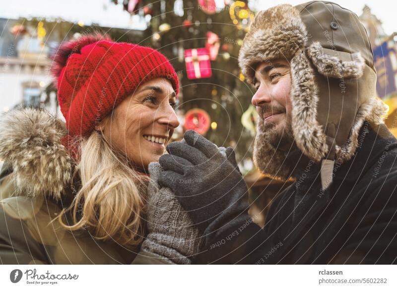 Romantic couple enjoying mulled wine on Christmas market love romantic new year drink xmas food hangout winter christmas woman snow christmas tree girl