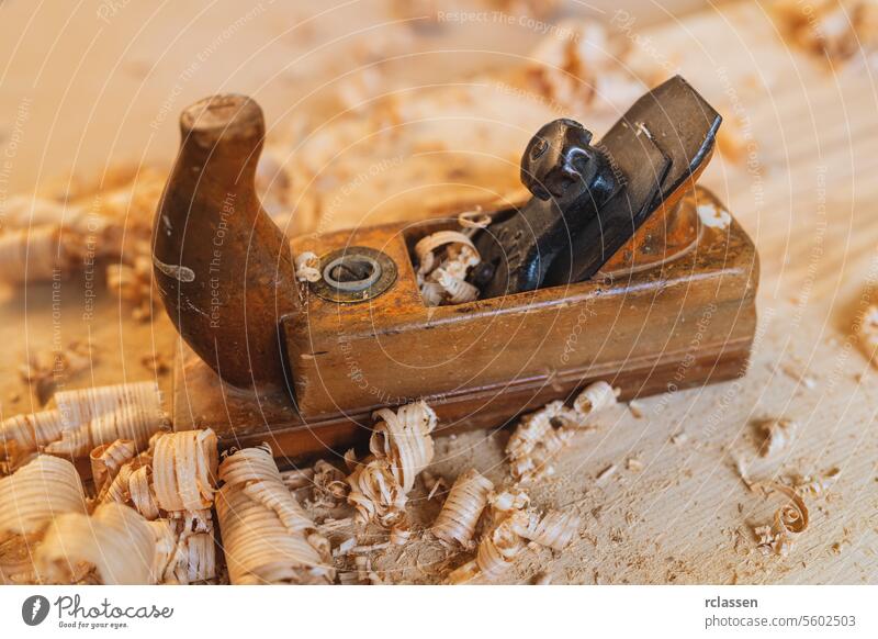 Old carpenter tool with wood shavings on wooden background old-fashioned carpenter tools carver blade workshop antique carving equipment handmade timber