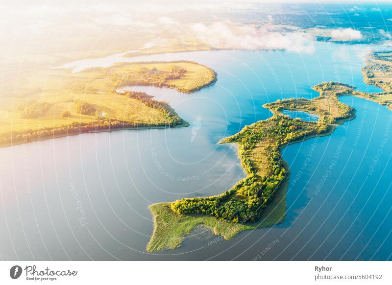 Amazing Scenic Aerial Bright Sunbeams View Green Meadow And River Landscape In Sunny Spring Day. Top View Of European Nature From High Attitude In Summer Season. Drone View. Bird's Eye View