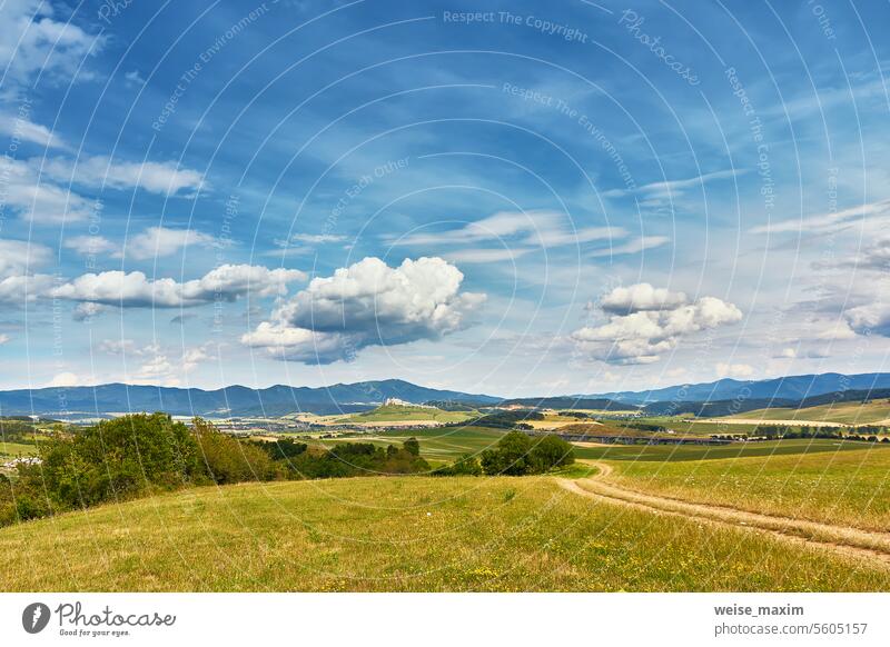 Slovakia summer landscape. Green summer fields, meadows, hills of Tatra mountains. Travel in vacations. Rural Road in Spis region, Slovakia. Spissky hrad national park