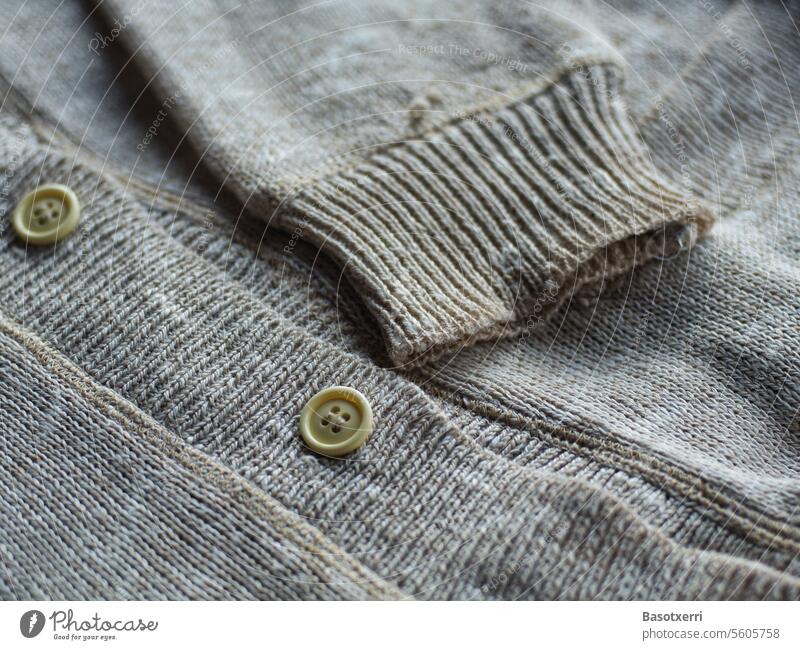 Close-up of a folded, not quite new cardigan with sleeves and buttons Cardigan Old Second-hand Detail Colour photo Deserted Interior shot Pattern