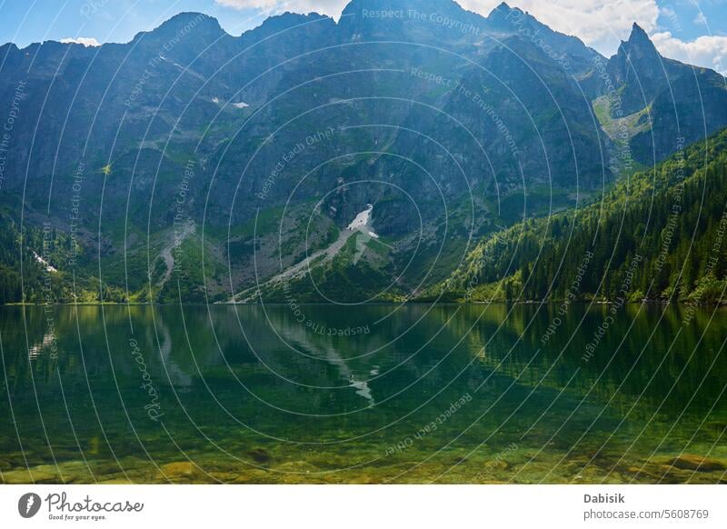 Mountains range near lake at summer day mountains nature travel landscape hiking peak morskie oko green national park water sky forest blue environment